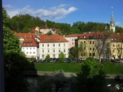 a group of buildings in a city with a river at Studio Ian in Ljubljana