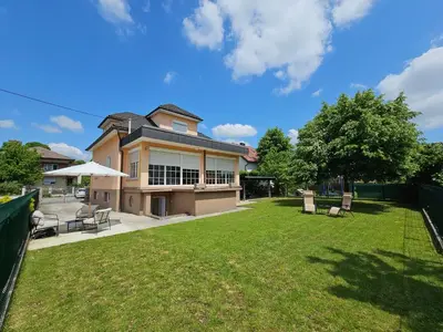 a large house with a yard with chairs at APARTMA FIREFLY1 in Ljubljana
