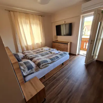 a bedroom with a bed and a flat screen tv at Soba pri nam in Gačnik