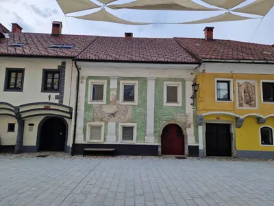 a building with a painting on the side of it at Sobe Lotrist in Radovljica