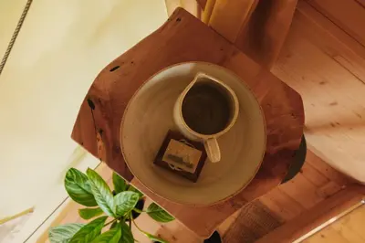 a cup of coffee and a piece of cake on a table at Ladybug Eco House in Gradišče pri Lukovici
