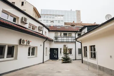 a christmas tree in a courtyard between two buildings at Apartment Center II - Kersnikova in Ljubljana