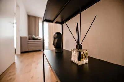 a room with a table with a vase on it at Sodoben apartma v centru Ljubljane in Ljubljana