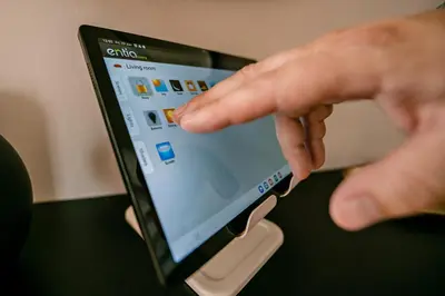 a person is pointing at a tablet computer screen at Apartma 2+2 v mestu Ljubljana (V325) in Ljubljana