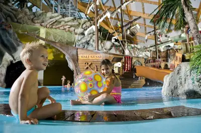 two children sitting in the water with a ball at Happy Camp Mobile Homes in Camping Terme Čatež in Čatež ob Savi
