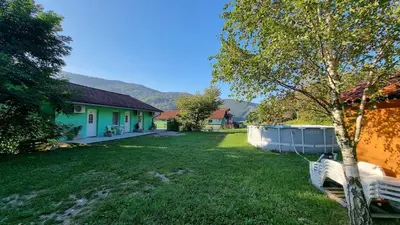 a yard with a house and a tub at Apartma Patricija for 2 in Tolmin