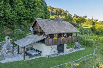 a model of a house with a cross and a church at Vineyard Cottage Skatlar in Otočec