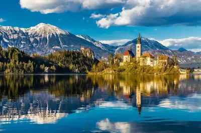 a church on an island in the middle of a lake at Tiny Bled house in Bled
