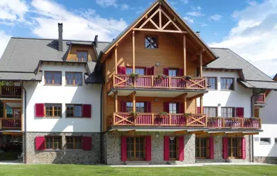 a large wooden house with red balconies at Stunning Apartment In Pohorje With Wifi in Pohorje