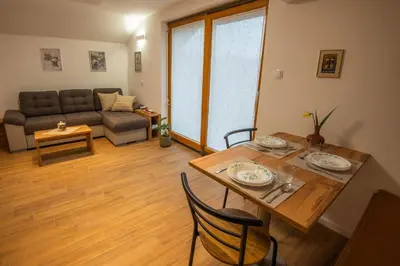 a living room with a table and a couch at Vineyard cottage Majolka in Novo Mesto