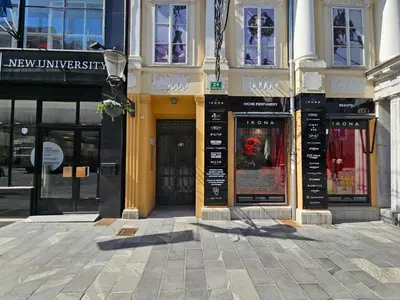 a building with signs on it on a city street at Relaxed escape in the old town - App Sviti Tour As in Ljubljana