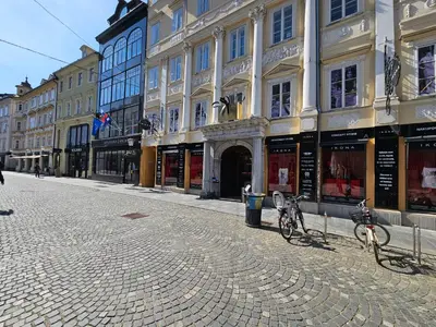 a cobblestone street with two bikes parked in front of buildings at Relaxed escape in the old town - App Sviti Tour As in Ljubljana