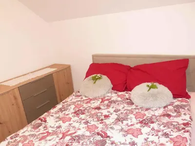a bedroom with a bed with two pillows on it at Holiday home in Dragatus - Kranjska (Krain) 50798 in Dragatuš