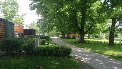 a winding road with trees and a building on the side at BIG BERRY KOLPA - KIWI mobile house, Metlika in Gradac