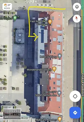 a map of a street with buildings and a yellow arrow at Little Plaza Duplex in Ljubljana