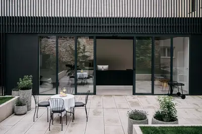 a patio with a table and chairs in front of a building at Villa Elizabeth - Grand Family Apartment in Slovenj Gradec