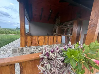 a porch of a building with flowers on it at Apartments LESKOVAR in Ormoz