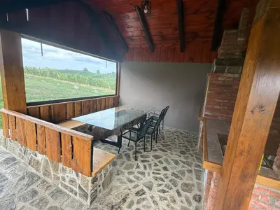 a dining room with a table and chairs and a window at Apartments LESKOVAR in Ormoz