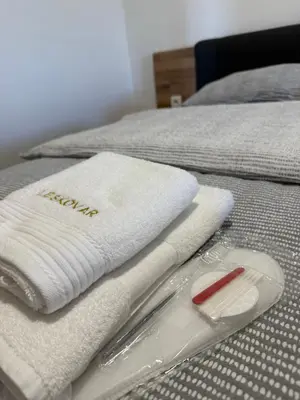 a bed with white towels on top of it at Apartma EVA in Ormoz