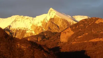 a view of a mountain range with snow covered mountains at Apartments Ručna in Kobarid