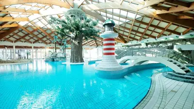 a swimming pool with a lighthouse in a building at Spa Cottage the Moon house Terme Čatež in Čatež ob Savi