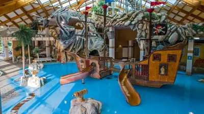 a childrens play area with slides and a playground at Family Holiday Home in Terme Čatež in Čatež ob Savi