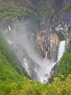 a waterfall on the side of a mountain at Holiday Home Kristi in Bovec