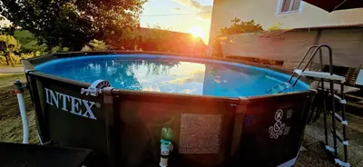 a hot tub in a yard with the sun setting at Apartma Martin in Miklavž pri Ormožu
