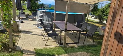 a table and chairs next to a swimming pool at Apartma Martin in Miklavž pri Ormožu