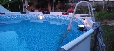 a swimming pool with a water slide in a yard at CAMP THEA, Glamping tent yurtas in Rose resort in Mrše