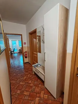 a room with a hallway and a room with a floor at apartma Pohorc - Kostanj in Pohorje