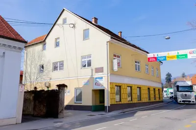 a white truck parked in front of a building at Apartma Pri Kosu in Slovenska Bistrica