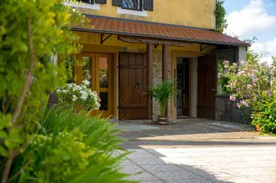 a front door of a house with flowers at Vineyard cottage Rustika in Novo Mesto