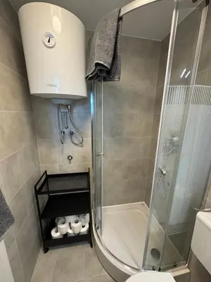 a bathroom with a shower and a toilet at Holzhaus in der Therme Čatež - familienfreundlich, Nähe WinterSommerRiviera in Brežice