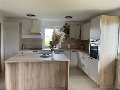 a kitchen with a island with a vase of flowers on it at Apartment9B with amazing view in Krško