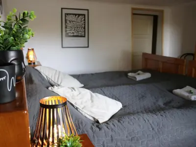 a bedroom with a bed and a table with a lamp at Vineyard cottage Ranč pri Hanzeku in Zgornji Leskovec