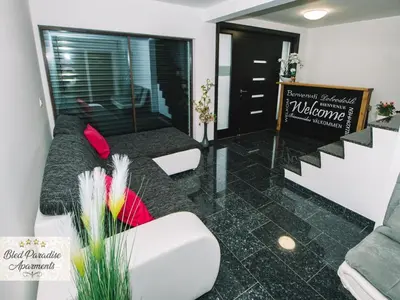 a living room with a couch and some chairs at Bled Prestigious and Stylish Apartments - Classic One Bedroom Apartment with Balcony in Bled