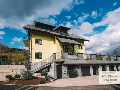 a large yellow building with a balcony at Bled Prestigious and Stylish Apartments - Standard Studio Apartment with Terrace in Bled