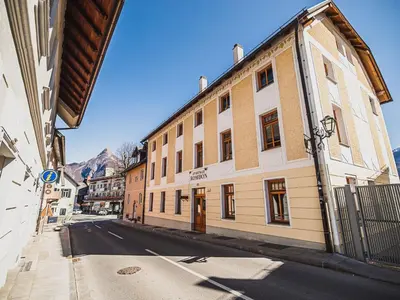 a street with a building on the side of the road at Bovec Picturesque Mountain Vista Residences - One Bedroom Apartment in Bovec