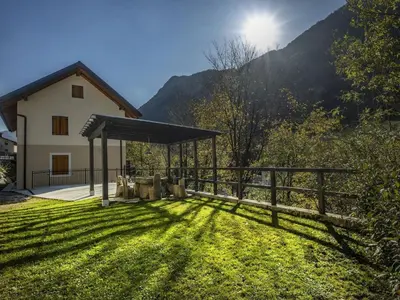 a house with a fence and a grass yard at Riverside Rustic Ridge Apartments with Balcony - Two Bedroom Apartment with Balcony in Slappe dʼIdria