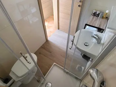 a small bathroom with a toilet and a sink at Peaceful Countryside Holiday Home with Terrace - One Bedroom Holiday Home with Terrace in Tolmin