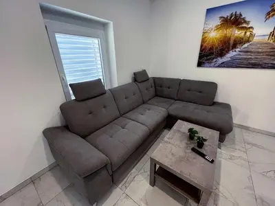 a living room with a couch and a coffee table at Delightful Cozy Riverside Apartment - One Bedroom Apartment with Terrace in Rečica ob Savinji