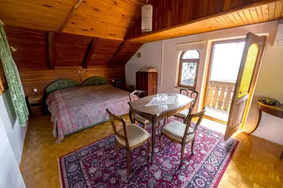 a bedroom with a bed and a table and chairs at Holiday Home with BBQ in Novo mesto 54727 in Novo Mesto