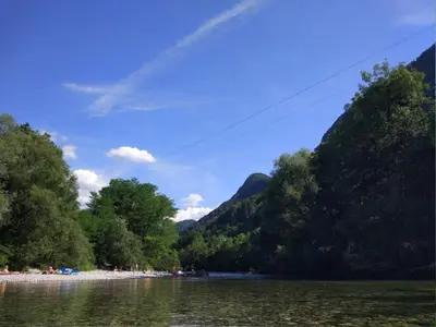 a body of water with trees and a mountain at Apartment mit eigener Sonnenterrasse by Interhome in Slappe dʼIdria