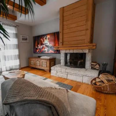 a living room with a fireplace and a couch at Apartma Mauro in Kranjska Gora