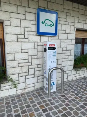 a parking meter with a sign next to a building at Žigon Bed & Breakfast in Logatec