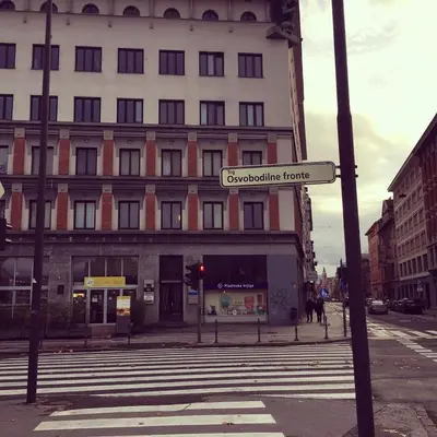 a street sign in front of a building at Studio apartment Sisters3 in Ljubljana