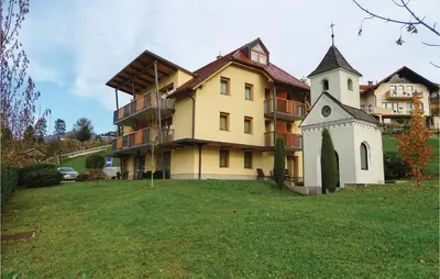 a large building with a clock tower in the yard at Stunning Apartment In Lasko With Wifi in Laško
