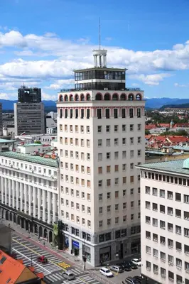 a large white building with a tower on top of it at Studio Optim in Ljubljana