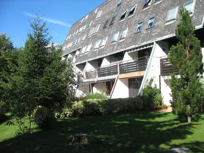 an apartment building with a lawn in front of it at Bovec Apartment in Bovec